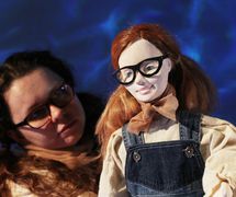 Ella puppet and Ella actor (Daisy Williams), in <em>The Lightning Path</em> (2016) by Small World Theatre (Cardigan, Wales, UK), direction: Ann Shrosbree, actors/puppeteers: Daisy Williams, Rhiannon Willis, Bill Hamblett. Ella puppet, height: 45 cm. Direct manipulation puppetry, shadows, multimedia (animation and sound), actors, masks. Photo: Sam Vicary